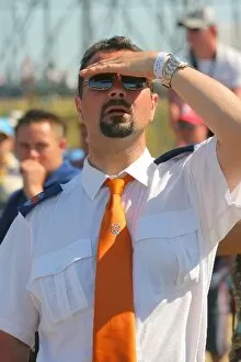 Images Dated 10th June 2006: Formula One World Championship: A security guard watches the football