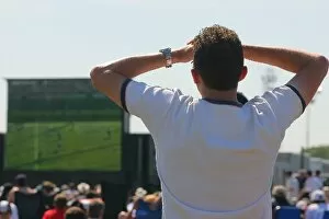 Images Dated 10th June 2006: Formula One World Championship: A spectator watches the football