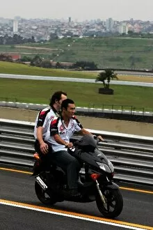 Images Dated 22nd September 2005: Formula One World Championship: Takuma Sato BAR rides the circuit on a moped