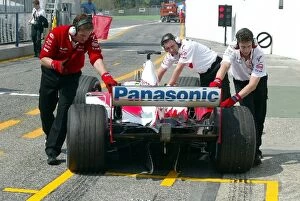 Images Dated 18th April 2003: Formula One World Championship: Toyota engineers push a Toyota back into the garage