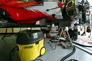 Images Dated 21st August 2003: Formula One World Championship: Toyota mechanics use a Karcher vacuum cleaner