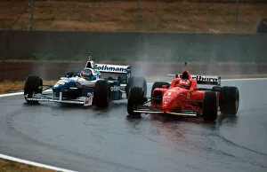 Gp Win Gallery: Formula One World Championship: Winner Michael Schumacher Ferrari F310 overtakes Villeneuve