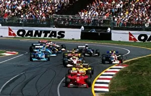 Australia Collection: Formula One World Championship: WinnerEddie IrvineFerrari F199 leads the midfield at the start