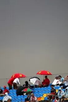 Images Dated 21st August 2005: GP2 Series: Fans shelter from the rain: GP2 Series, Rd18, Istanbul Park, Istanbul, Turkey