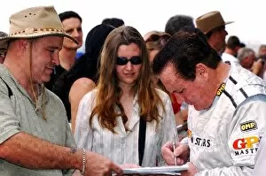 Images Dated 17th November 2005: Grand Prix Masters: Alan Jones signs autographs for the fans