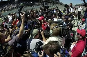 Images Dated 27th May 2002: Helio Castroneves (BRA) Team Penske is mobbed by the media following his controversial victory of