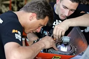 Mechanic Gallery: Le Mans 24 Hours: A mechanic works on a light housing before the race