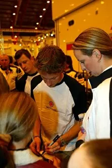 Images Dated 15th December 2003: MPH03 Show: Jenson Button BAR signs autographs for fans