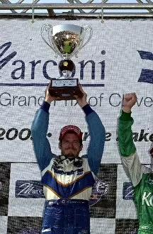 Images Dated 15th July 2002: Patrick Carpentier holds the winners trophy proudly after winning his first CART road race at