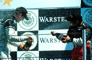 Images Dated 16th April 2001: Porsche Supercup: Race winner Jorg Bermeister has a champagne fight with 3rd place Stephane Ortelli