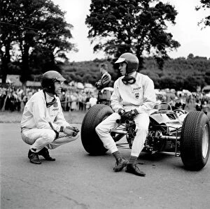 Images Dated 22nd August 2013: Spa-Francorchamps, Belgium: Jim Clark has a chat with Dan Gurney whilst sitting on his Lotus 25