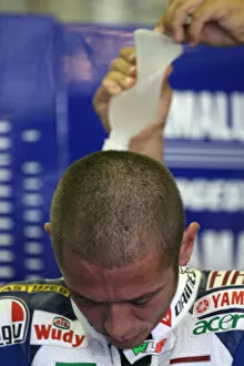 Images Dated 15th August 2008: Valentino Rossi Fiat Yamaha Team gets his water drinking system refilled before Free Practice 2