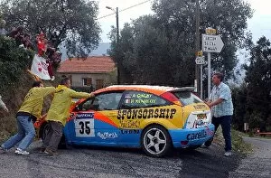 2003 WRC Gallery: World Rally Championship: Alistair Ginley, Ford Focus, is pushed by the marshals after his car