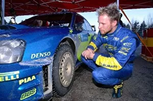 Sweden Collection: World Rally Championship: Petter Solberg Subaru checks the studs on his tyres
