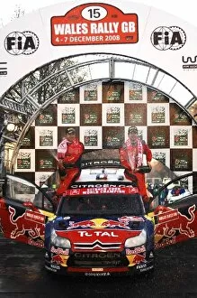 Cardiff Gallery: World Rally Championship: Sebastien Loeb and Daniel Elena Citroen spray the winners champagne on the podium